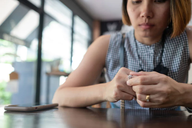 woman pulling out ring in distress